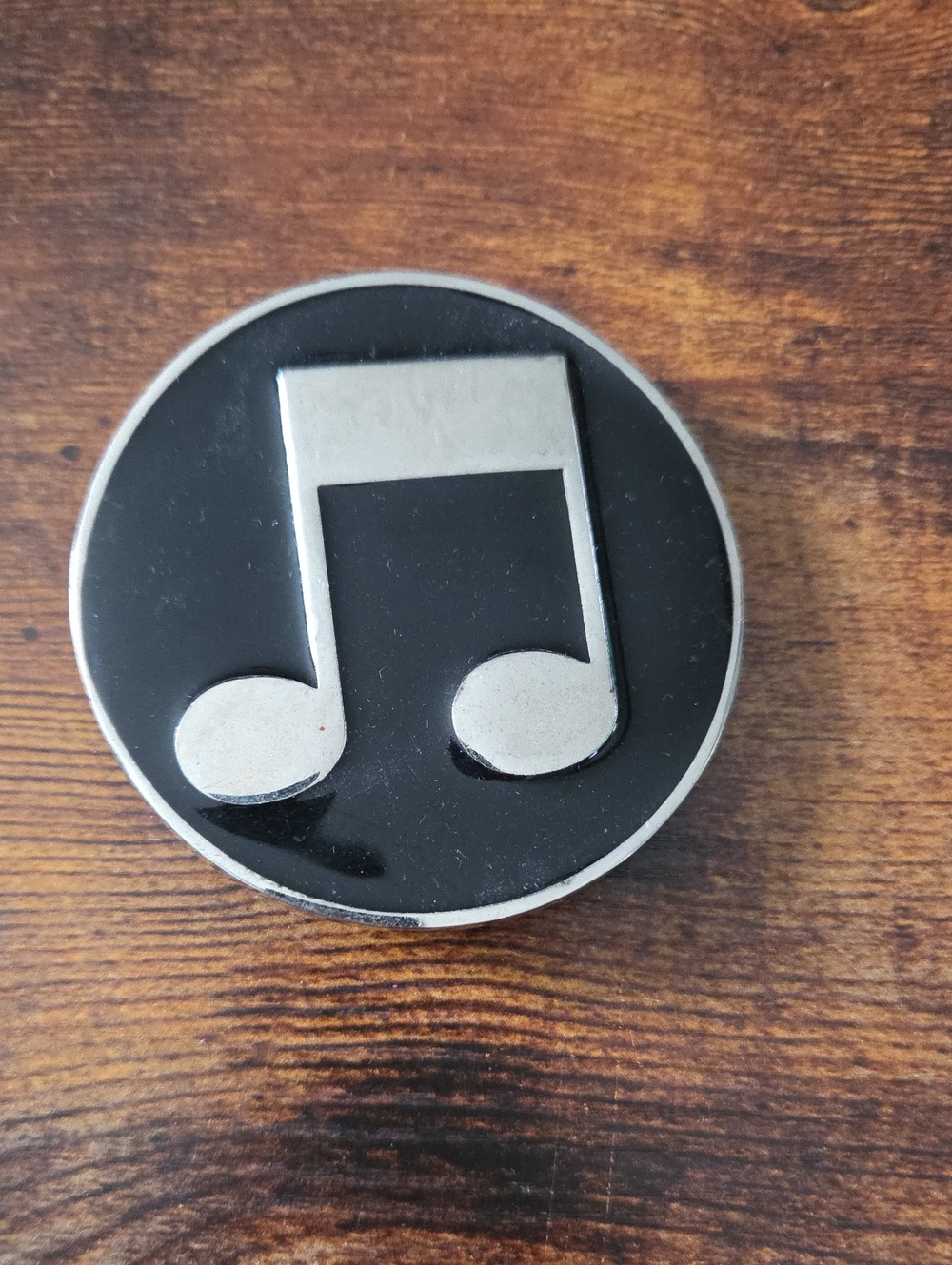 circular silver and black musical note belt buckle